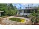 Backyard with an in-ground pool, house with screened enclosure, and established trees at 7111 Oregon Chickadee Rd, Weeki Wachee, FL 34613