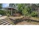 Backyard oasis featuring a hot tub, gazebo, landscaping, and a tranquil outdoor space at 7111 Oregon Chickadee Rd, Weeki Wachee, FL 34613