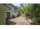 Backyard with a garage, AC Unit, and greenery leading to the pool at 7111 Oregon Chickadee Rd, Weeki Wachee, FL 34613