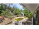 Backyard featuring an overgrown pool and surrounding foliage, visible from the house at 7111 Oregon Chickadee Rd, Weeki Wachee, FL 34613