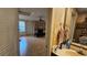 View through the bathroom towards the living room with a stone fireplace and bench seating at 7111 Oregon Chickadee Rd, Weeki Wachee, FL 34613