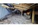 View of the crawl space under the house, showing insulation and utilities at 7111 Oregon Chickadee Rd, Weeki Wachee, FL 34613