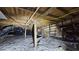 A view of the crawl space under the house, showing the wooden beams, insulation, and utility lines at 7111 Oregon Chickadee Rd, Weeki Wachee, FL 34613