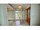 Bright foyer with tile flooring, a large window, and a wooden front door at 7111 Oregon Chickadee Rd, Weeki Wachee, FL 34613