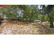 Front yard with mature trees shading the property and driveway at 7111 Oregon Chickadee Rd, Weeki Wachee, FL 34613