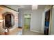 Hallway with tile flooring, dressing area with mirror and closet at 7111 Oregon Chickadee Rd, Weeki Wachee, FL 34613