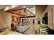 Open-concept kitchen with island, granite counters, vaulted ceiling, and exposed wood beams at 7111 Oregon Chickadee Rd, Weeki Wachee, FL 34613