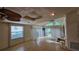 Bright living room featuring hardwood floors, high ceilings, skylights, ceiling fans and sliding glass doors to the outside at 7111 Oregon Chickadee Rd, Weeki Wachee, FL 34613
