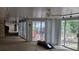 Living room with ceiling fan and sliding doors leading to balcony at 7111 Oregon Chickadee Rd, Weeki Wachee, FL 34613