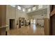 Open living room with wood floors, tall ceilings, and access to other rooms, creating a spacious feel at 7111 Oregon Chickadee Rd, Weeki Wachee, FL 34613