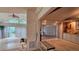 Open living area featuring hardwood floors, with an adjacent carpeted sunroom and built ins at 7111 Oregon Chickadee Rd, Weeki Wachee, FL 34613