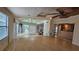 Large, sun-filled room with hardwood floors, access to sunroom, and high ceilings at 7111 Oregon Chickadee Rd, Weeki Wachee, FL 34613