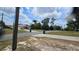 Charming neighborhood street view, featuring a well-manicured lawn and mature trees at 7111 Oregon Chickadee Rd, Weeki Wachee, FL 34613