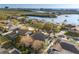 Aerial neighborhood view featuring waterfront access, mature trees, and a mix of home styles at 8083 Bayhaven Dr, Seminole, FL 33776