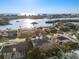 Scenic aerial view of waterfront homes and buildings, showcasing lush greenery and shimmering waters at 8083 Bayhaven Dr, Seminole, FL 33776