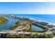 Stunning aerial view showcasing beachfront real estate, blue waters, and scenic coastal highways at 8083 Bayhaven Dr, Seminole, FL 33776
