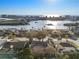 Aerial view of residential homes with lush greenery and a bridge leading to waterfront buildings at 8083 Bayhaven Dr, Seminole, FL 33776