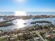 Scenic aerial view of waterfront homes and buildings, showcasing lush greenery and shimmering waters at 8083 Bayhaven Dr, Seminole, FL 33776