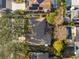 Aerial view of home with backyard pool, lush trees, and solar panels on a neighboring property at 8083 Bayhaven Dr, Seminole, FL 33776