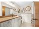 Well-lit bathroom with a large mirror and neutral color scheme at 8083 Bayhaven Dr, Seminole, FL 33776