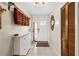 Inviting entryway with white shoe storage and decor; decorative mirror hangs on the wall at 8083 Bayhaven Dr, Seminole, FL 33776