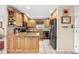 Well-lit kitchen with light wood cabinets, granite countertops, and stainless steel appliances at 8083 Bayhaven Dr, Seminole, FL 33776