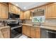 Updated kitchen boasts granite countertops, stainless steel appliances, and wood cabinetry at 8083 Bayhaven Dr, Seminole, FL 33776