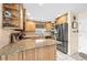 Lovely kitchen with stainless steel appliances, light wood cabinets and granite countertops at 8083 Bayhaven Dr, Seminole, FL 33776