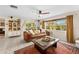 Spacious living room featuring a comfortable leather sofa, large windows, and stylish decor at 8083 Bayhaven Dr, Seminole, FL 33776