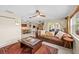 Open-concept living area with a cozy sofa, a natural wood table, with dining room in the background at 8083 Bayhaven Dr, Seminole, FL 33776