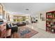 Comfortable living room with tile floors, guitars, and an area rug at 8083 Bayhaven Dr, Seminole, FL 33776
