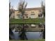 The backyard features lush green grass and pond views for a relaxing outdoor experience at 8105 Sheldon Shores Dr, Tampa, FL 33615