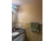Bathroom featuring a granite countertop and stone-look tile backsplash and walls at 8105 Sheldon Shores Dr, Tampa, FL 33615
