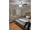 Bedroom featuring wood floors, dresser, large bed, and neutral colored walls at 8105 Sheldon Shores Dr, Tampa, FL 33615