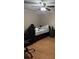 Bedroom showcasing a dark-wood bed frame with laminate wood floor at 8105 Sheldon Shores Dr, Tampa, FL 33615