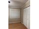 Bedroom featuring modern white closet and neutral colored walls with laminate wood floor at 8105 Sheldon Shores Dr, Tampa, FL 33615