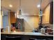 Well-lit kitchen with bar seating, stainless steel appliances, and ample countertop space at 8105 Sheldon Shores Dr, Tampa, FL 33615