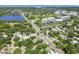 Aerial view showcases a neighborhood near a lake, complemented by surrounding amenities and lush green spaces at 905 8Th Sw Ave, Largo, FL 33770