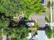 Aerial view showcases the layout of the home, the lush backyard with a fire pit, and RV parking at 905 8Th Sw Ave, Largo, FL 33770