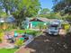 Inviting backyard with a charming fire pit, patio area, artificial grass and parking for RV at 905 8Th Sw Ave, Largo, FL 33770