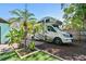 Expansive backyard featuring RV parking, lush landscaping, and a welcoming patio for outdoor relaxation and entertainment at 905 8Th Sw Ave, Largo, FL 33770