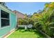 The backyard features artificial turf, tropical plants, and a decorative chair, great for relaxing at 905 8Th Sw Ave, Largo, FL 33770