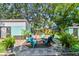 Charming backyard featuring a brick patio, landscaping, an outdoor gathering space, and lush greenery at 905 8Th Sw Ave, Largo, FL 33770