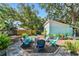 Inviting backyard featuring a brick patio with chairs and landscaping, great for outdoor enjoyment and relaxation at 905 8Th Sw Ave, Largo, FL 33770