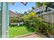 Backyard featuring tropical plants, new artificial turf, and a decorative chair, great for relaxing at 905 8Th Sw Ave, Largo, FL 33770