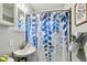 Charming bathroom featuring a sink, mirror, shower with a blue and white curtain at 905 8Th Sw Ave, Largo, FL 33770