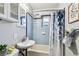 Bright bathroom with a sink, shower with blue tile, and decorative shower curtain at 905 8Th Sw Ave, Largo, FL 33770