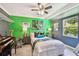Colorful bedroom with a window, lamps, artwork, and zebra and giraffe decor at 905 8Th Sw Ave, Largo, FL 33770