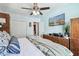 Bright bedroom featuring a ceiling fan, TV, wooden dresser, and natural light at 905 8Th Sw Ave, Largo, FL 33770