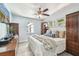Light and airy bedroom featuring a ceiling fan, two windows, and classic wood bedroom set at 905 8Th Sw Ave, Largo, FL 33770